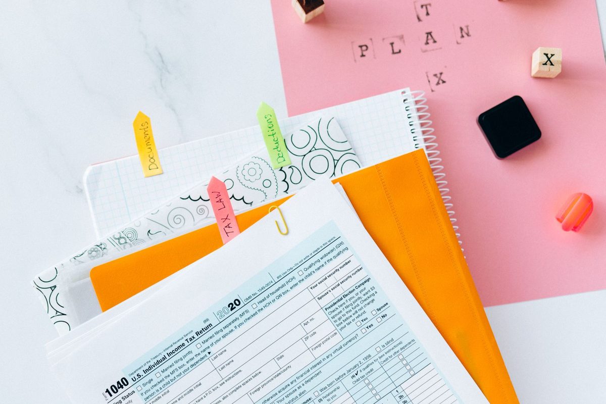 A 1040 tax form and documents spread on a desk