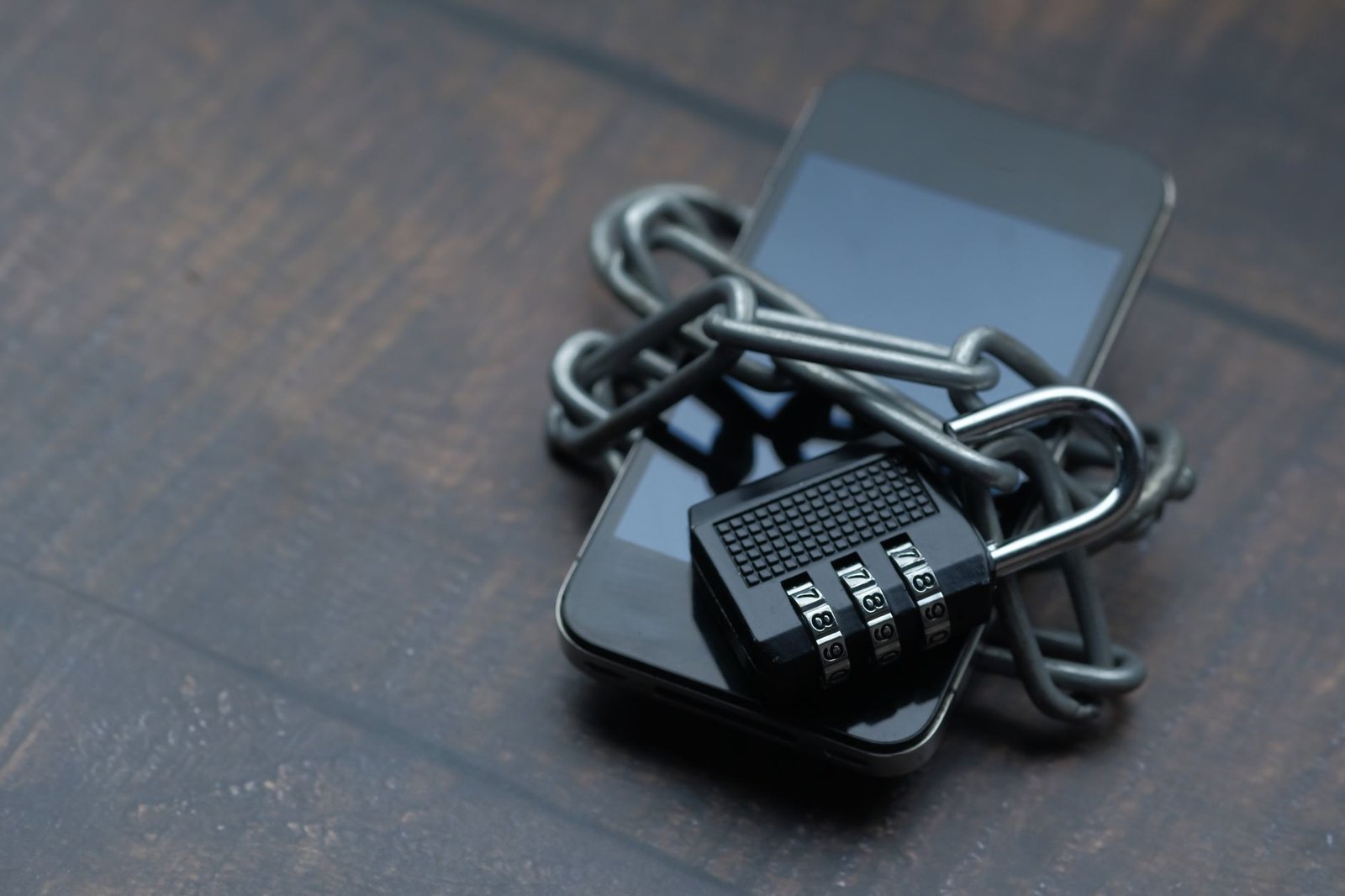 Smartphone wrapped in a chain and padlock, symbolizing phone privacy